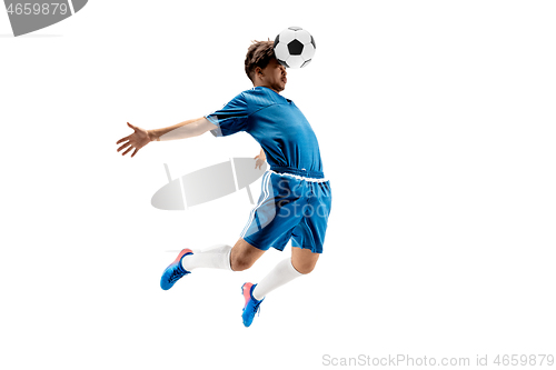 Image of Young boy with soccer ball doing flying kick