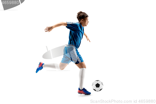 Image of Young boy with soccer ball doing flying kick