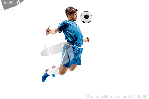 Image of Young boy with soccer ball doing flying kick