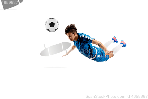 Image of Young boy with soccer ball doing flying kick