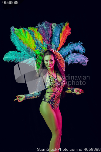 Image of Beautiful young woman in carnival peacock costume