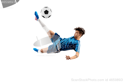 Image of Young boy with soccer ball doing flying kick