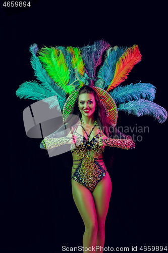 Image of Beautiful young woman in carnival peacock costume