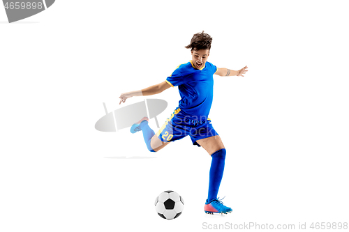 Image of Young boy with soccer ball doing flying kick