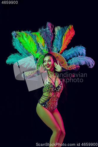 Image of Beautiful young woman in carnival peacock costume