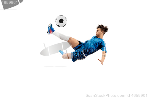 Image of Young boy with soccer ball doing flying kick