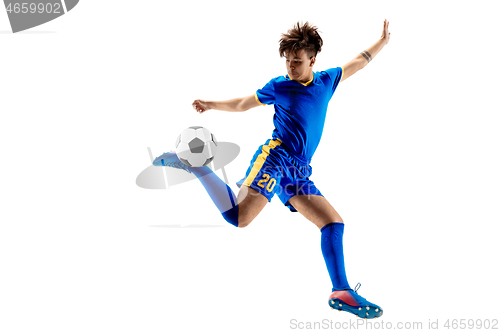 Image of Young boy with soccer ball doing flying kick