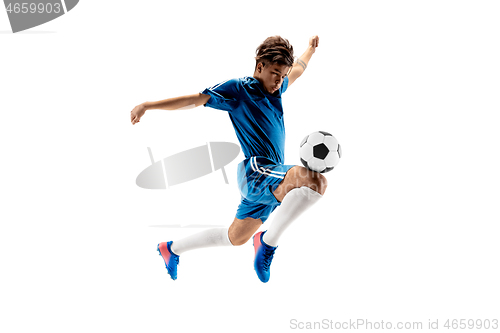 Image of Young boy with soccer ball doing flying kick