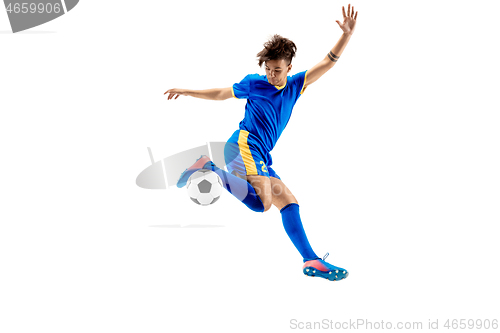 Image of Young boy with soccer ball doing flying kick