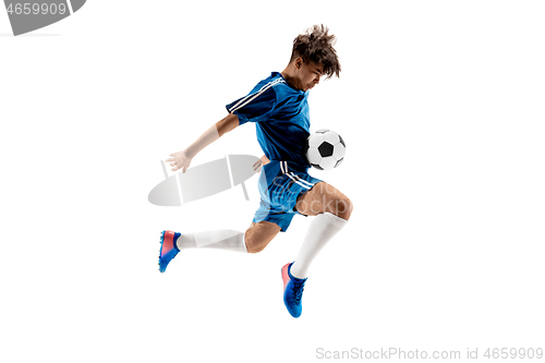 Image of Young boy with soccer ball doing flying kick