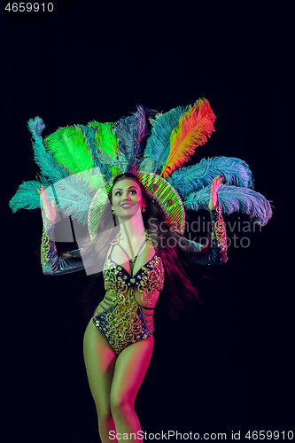 Image of Beautiful young woman in carnival peacock costume