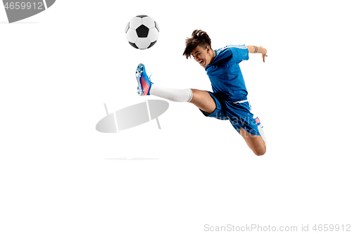 Image of Young boy with soccer ball doing flying kick