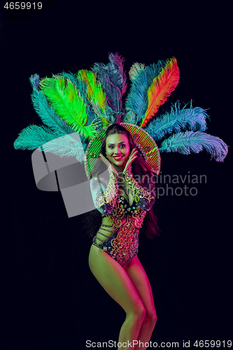 Image of Beautiful young woman in carnival peacock costume