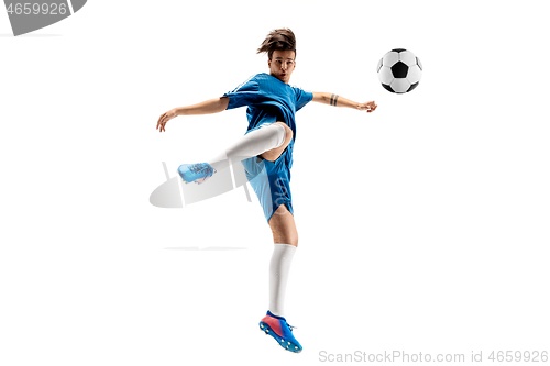 Image of Young boy with soccer ball doing flying kick