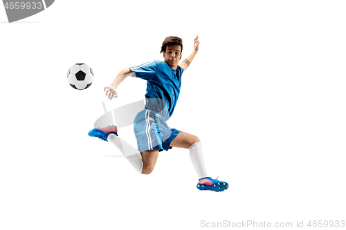 Image of Young boy with soccer ball doing flying kick