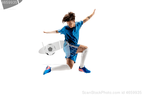 Image of Young boy with soccer ball doing flying kick