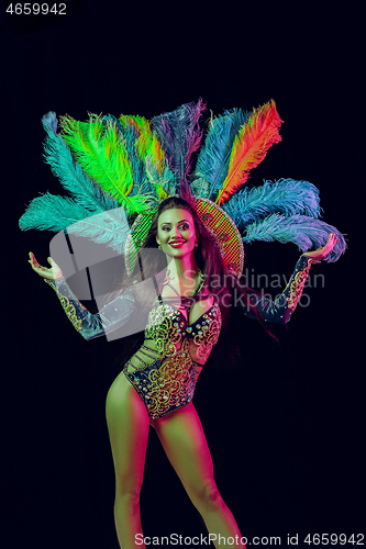 Image of Beautiful young woman in carnival peacock costume