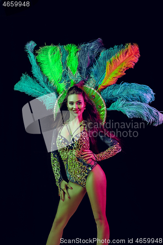 Image of Beautiful young woman in carnival peacock costume