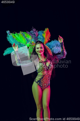 Image of Beautiful young woman in carnival peacock costume