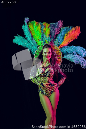 Image of Beautiful young woman in carnival peacock costume