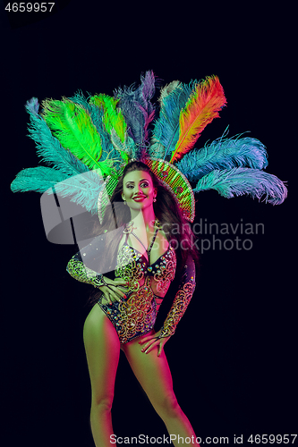 Image of Beautiful young woman in carnival peacock costume