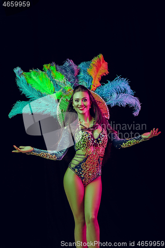 Image of Beautiful young woman in carnival peacock costume