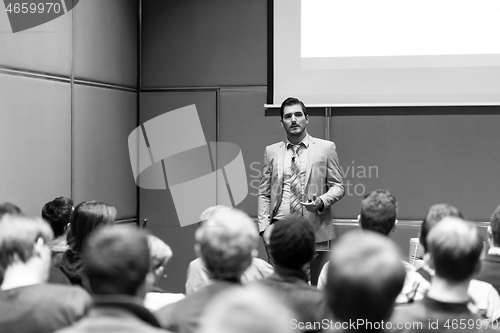 Image of Business speaker giving a talk at business conference meeting event.