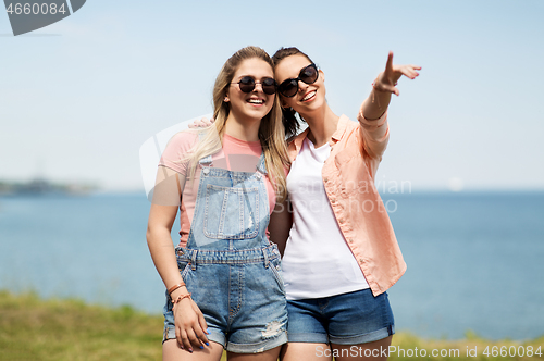 Image of teenage girls or best friends at seaside in summer