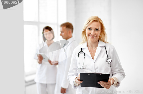 Image of smiling doctor with clipboard and stethoscope