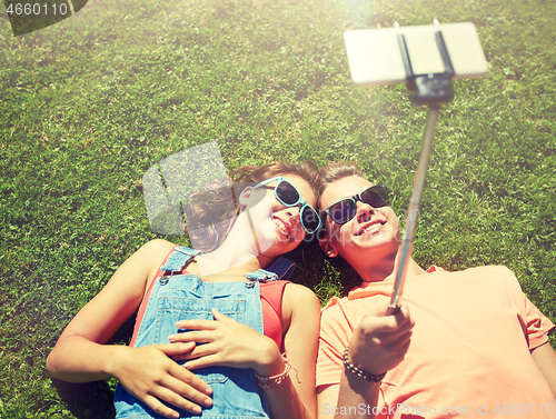 Image of happy couple taking selfie on smartphone at summer