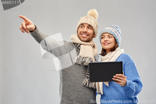 Image of couple in winter clothes with tablet computer