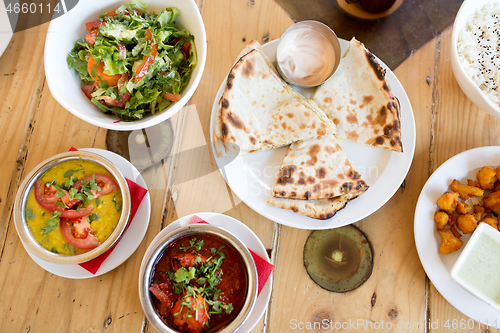 Image of various food on table of indian restaurant