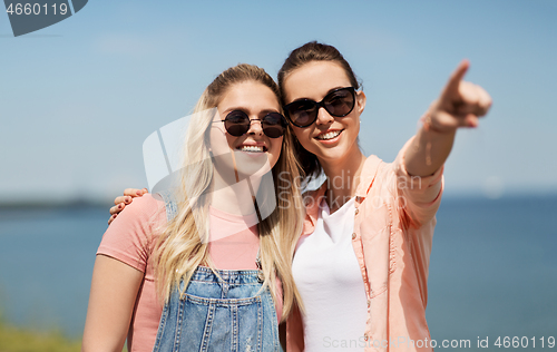 Image of teenage girls or best friends at seaside in summer