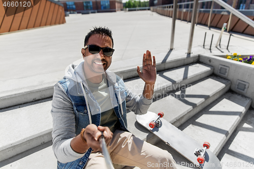 Image of indian man taking selfie on roof top