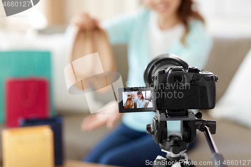 Image of asian female fashion blogger making video of shoes