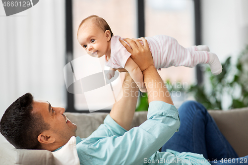 Image of happy middle aged father with baby at home