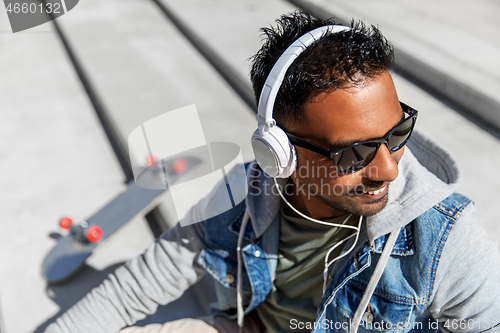 Image of indian man in headphones listening to music