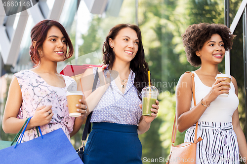 Image of women with shopping bags and drinks in city