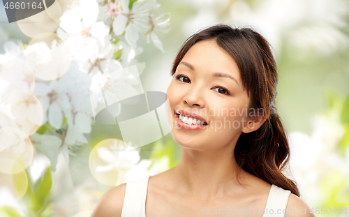 Image of face of happy smiling young asian woman