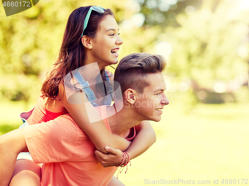 Image of happy teenage couple having fun at summer park