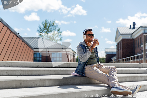 Image of man in headphones listening to music on roof top