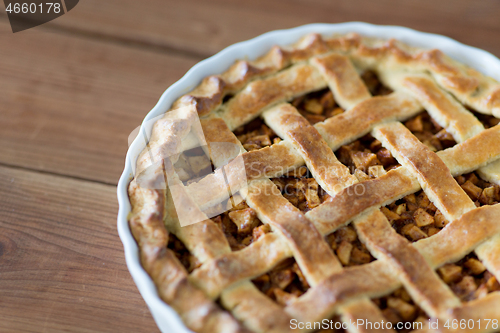 Image of close up of apple pie on wooden table