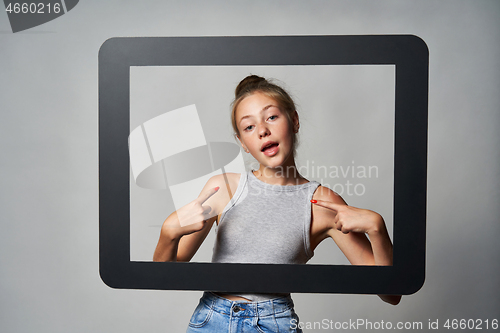 Image of Cute teen girl giving some attitude posing pointing at herself