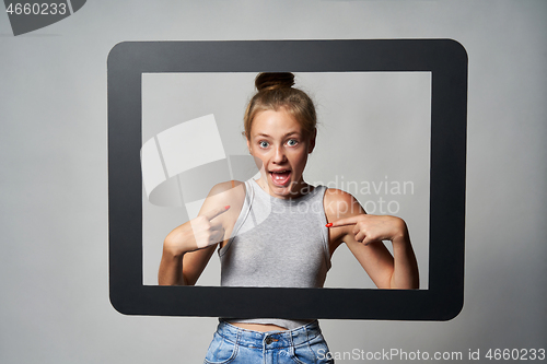 Image of Cute teen girl giving some attitude posing pointing at herself