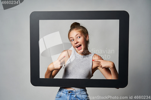 Image of Cute teen girl giving some attitude posing pointing at herself