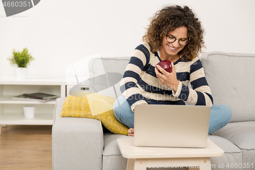 Image of Beautiful woman working at home