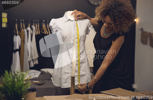 Image of Fashion designer on her Atelier