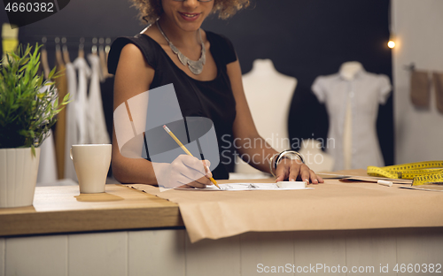 Image of Fashion designer on her Atelier