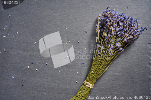 Image of A bunch of lavender flowers on on stone surface