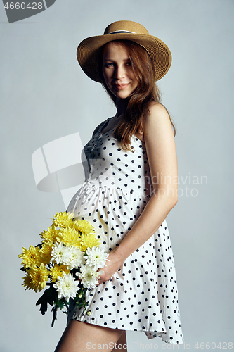 Image of Pregnant woman in white boyfriend shirt over white background